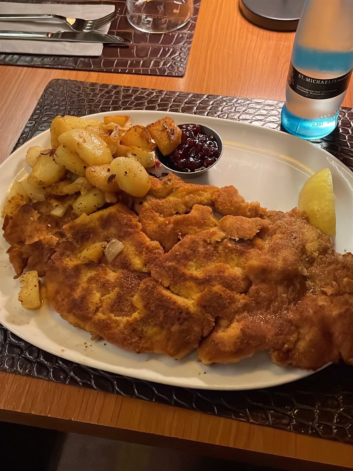 Large Wiener schnitzel with fried potatoes, lemon, and jam at Old Commercial Room