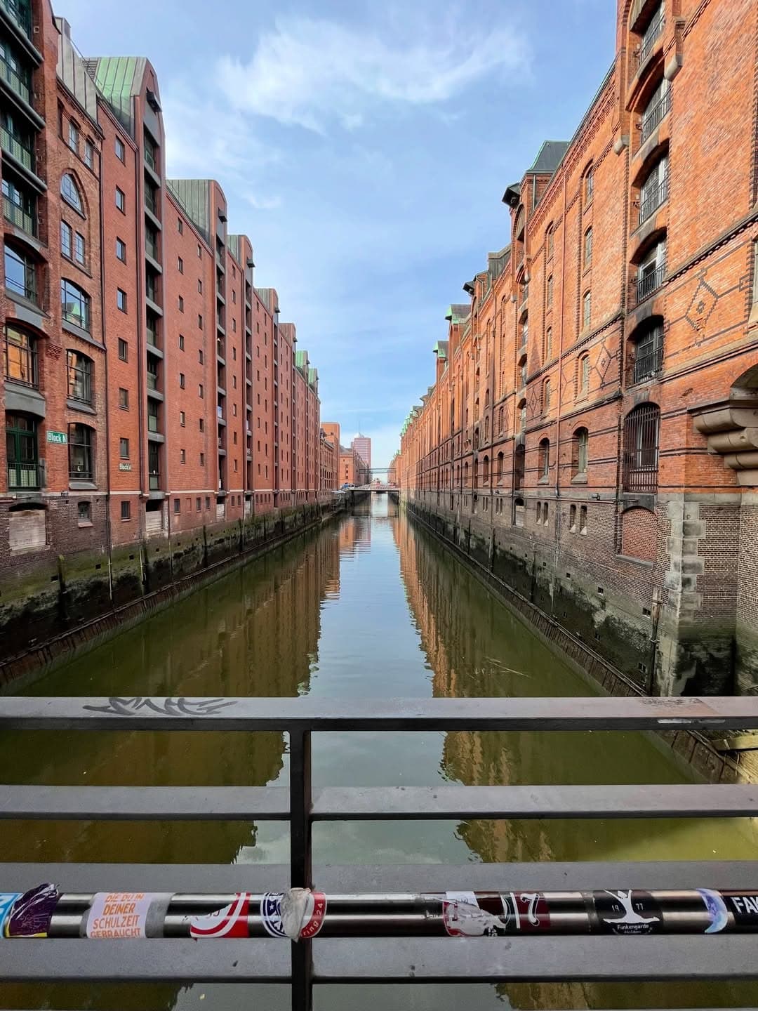 Red-brick Speicherstadt warehouses reflected in a Hamburg canal