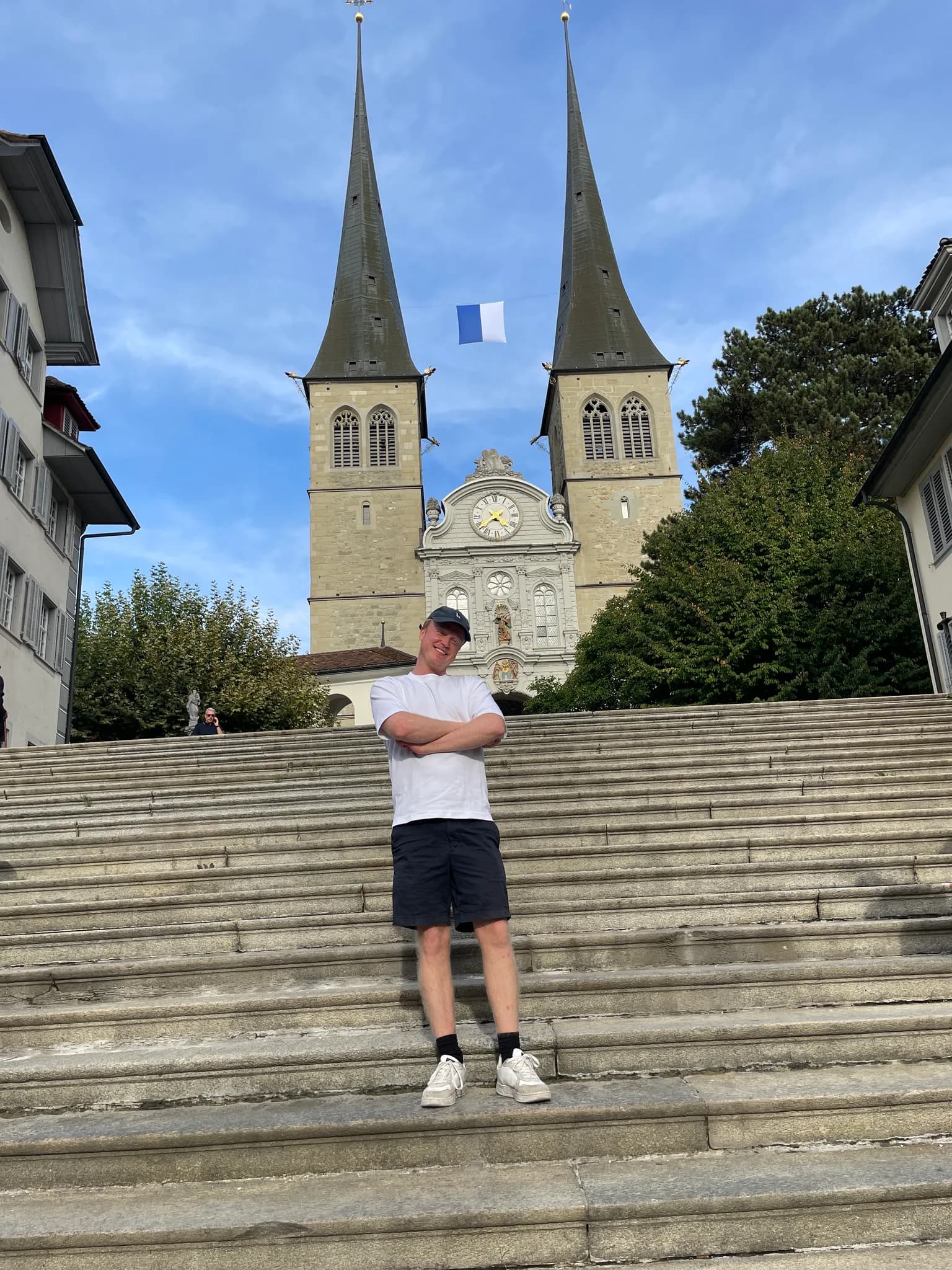 Traveller standing outside Hofkirche St. Leodegar in Lucerne