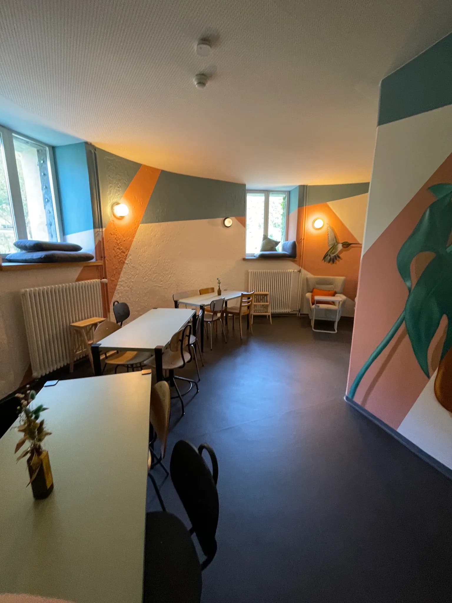 Bright coworking and communal dining space inside Bogentrakt Hostel Chur