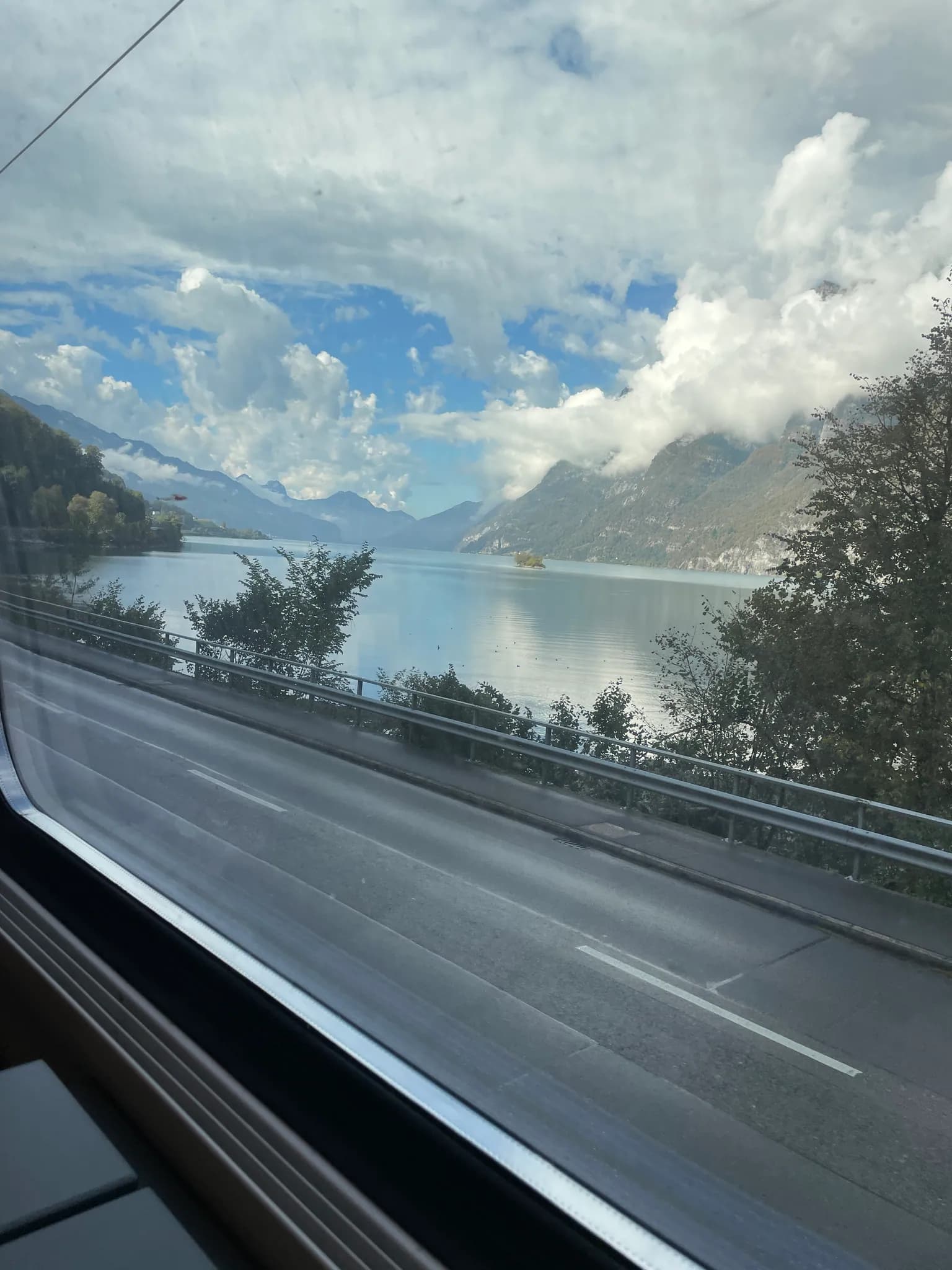 Walensee and steep mountains seen through the train window between Zürich and Chur