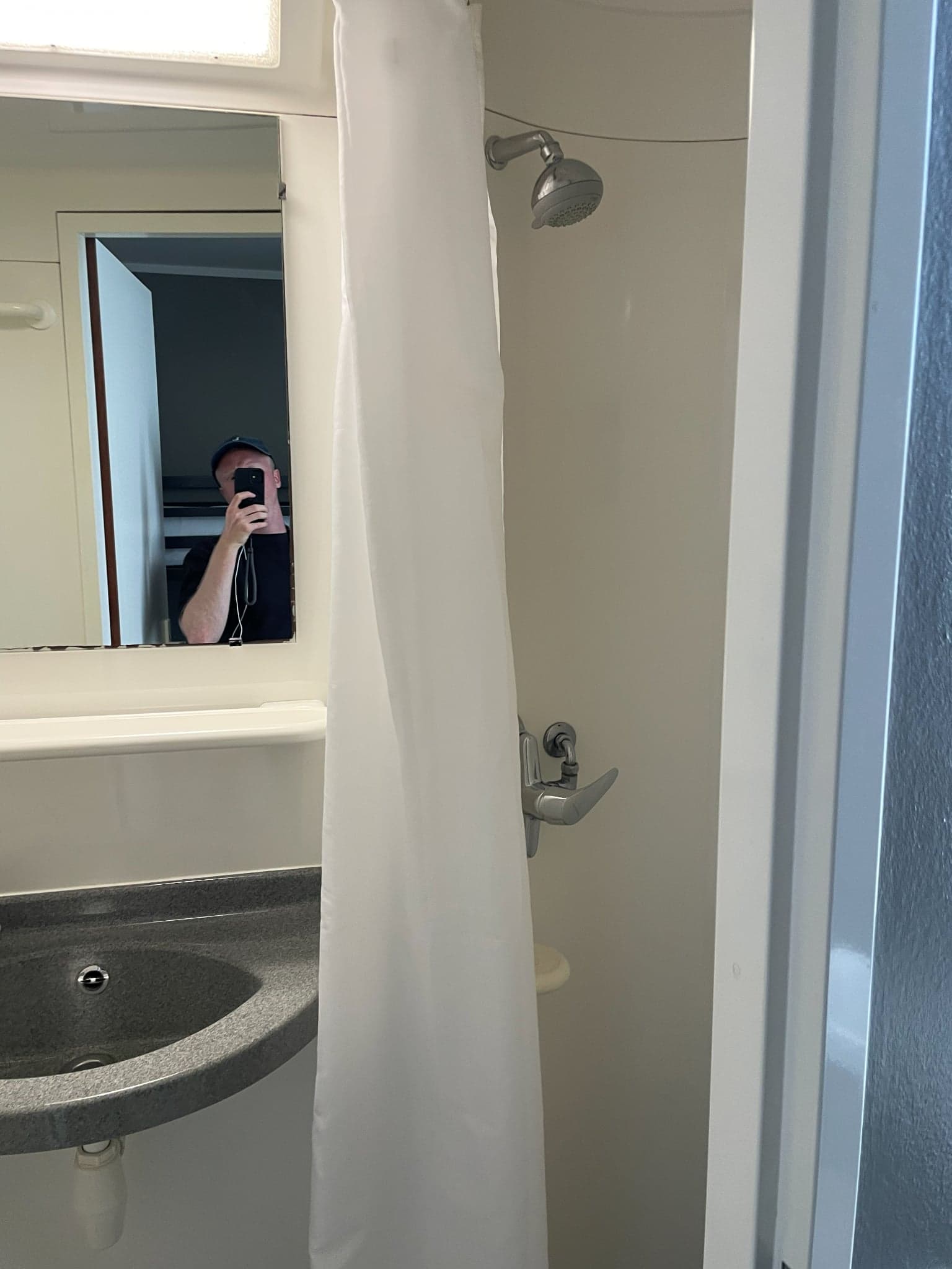 Compact ensuite shower and sink in a dorm at Generator Hostel Hamburg