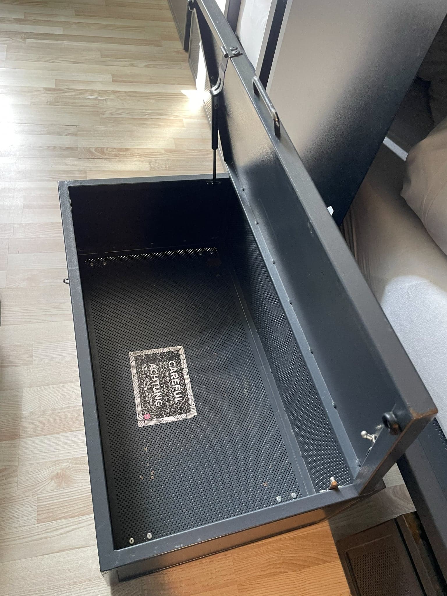 Large open under-bed luggage locker in a dorm at Generator Hostel Hamburg