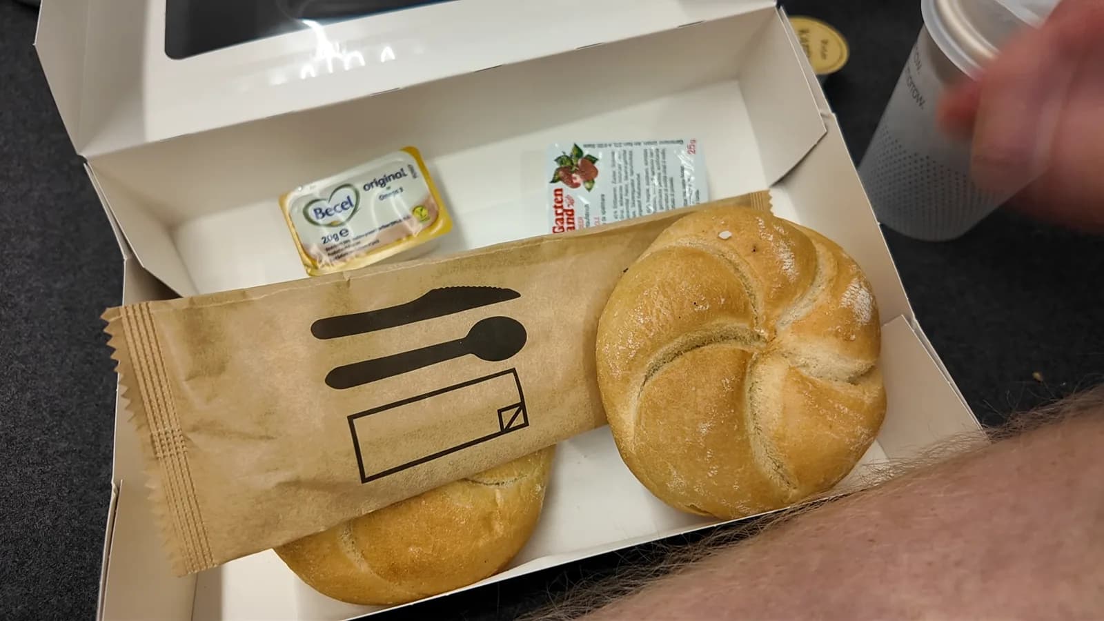 Nightjet Mini Cabin breakfast with bread rolls, butter, jam, coffee, and milk