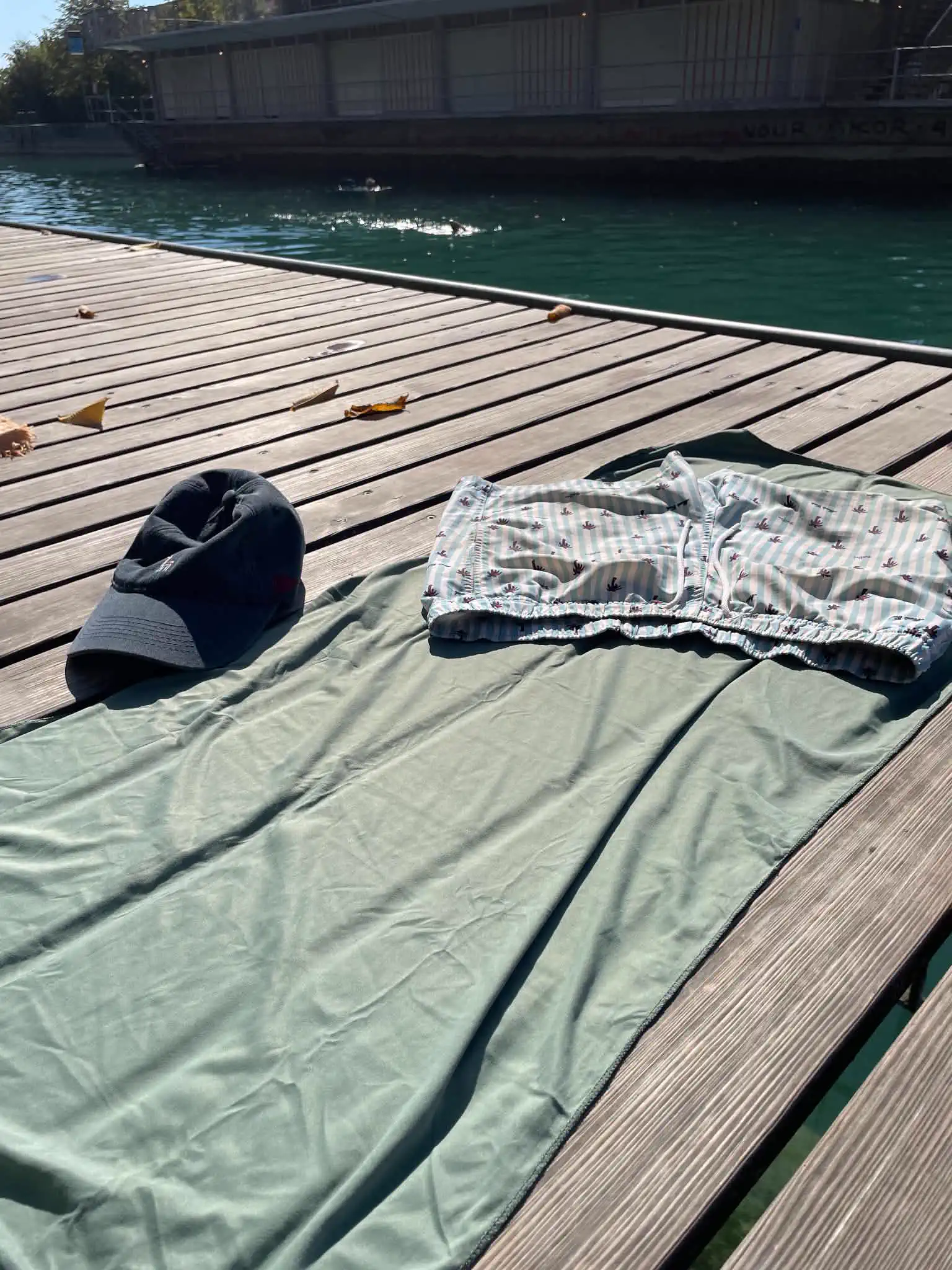 Microfibre towel and swimming shorts on a wooden deck beside the Limmat near Dynamo in Zürich