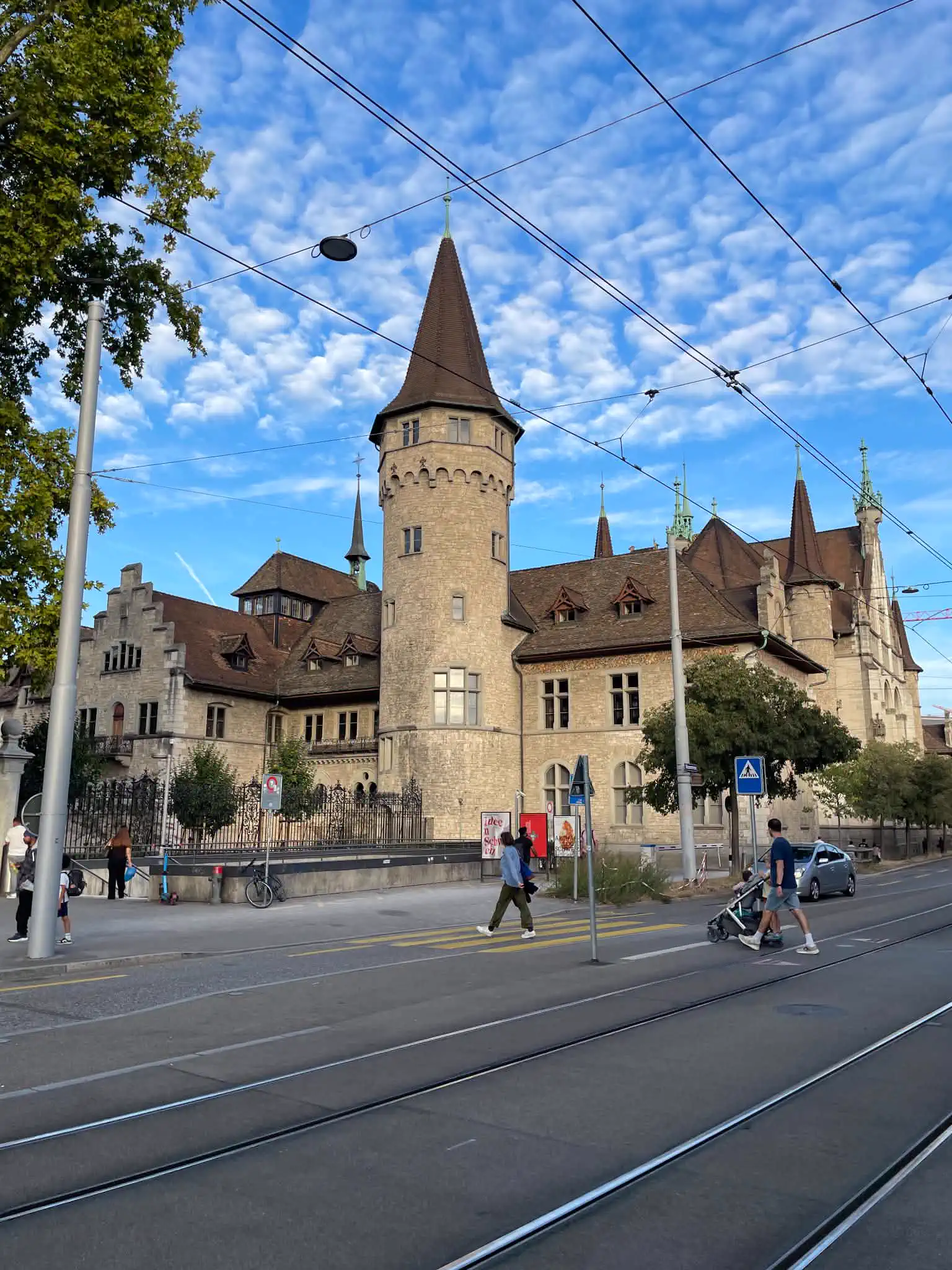 Historic exterior of the Swiss National Museum beside tram tracks in Zürich